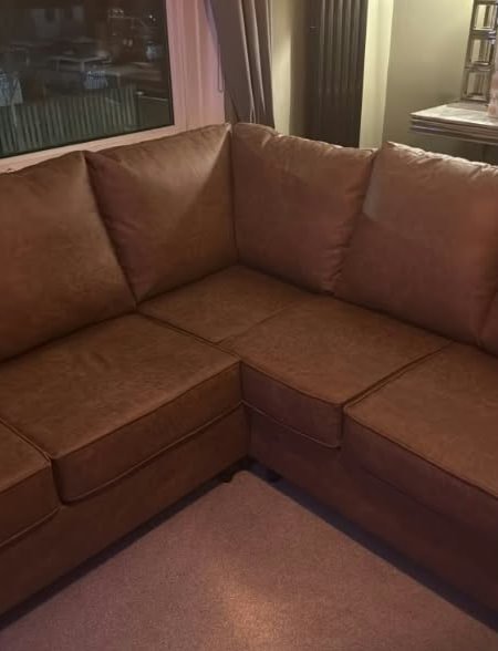 A tan corner sofa in a customer’s living room